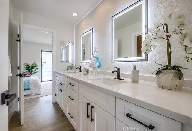 658 S Webster Ave Unit 4, Anaheim, CA 92804 - ensuite bathroom featuring double vanity, wood finished floors, and recessed lighting