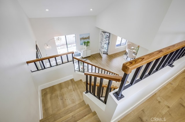 658 S Webster Ave Unit 4, Anaheim, CA 92804 - stairway featuring wood finished floors, high vaulted ceiling, baseboards, and recessed lighting