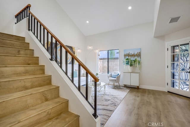 658 S Webster Ave Unit 4, Anaheim, CA 92804 - stairway with wood finished floors, high vaulted ceiling, recessed lighting, and baseboards