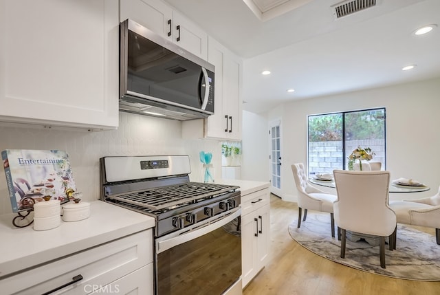 658 S Webster Ave Unit 4, Anaheim, CA 92804 - kitchen with appliances with stainless steel finishes, white cabinets, light countertops, and recessed lighting