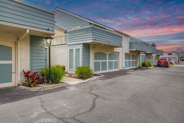 658 S Webster Ave Unit 4, Anaheim, CA 92804 - view of home's exterior featuring a balcony, a garage, and driveway