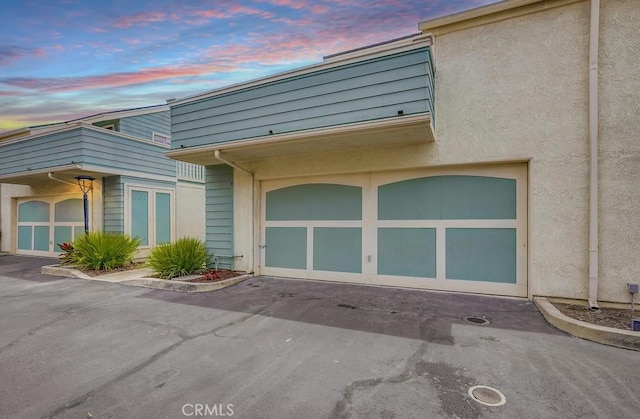 658 S Webster Ave Unit 4, Anaheim, CA 92804 - view of side of home featuring driveway, a garage, and stucco siding