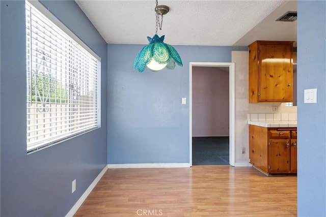 1254 Fieldgate Ave, Hacienda Heights, CA 91745 - unfurnished dining area featuring light wood finished floors and a textured ceiling