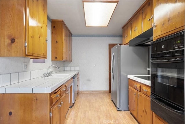 1254 Fieldgate Ave, Hacienda Heights, CA 91745 - kitchen with appliances with stainless steel finishes, a warming drawer, ventilation hood, brown cabinets, and tile counters