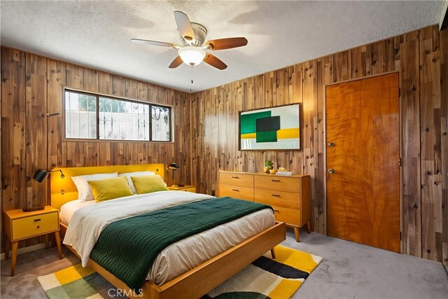 1254 Fieldgate Ave, Hacienda Heights, CA 91745 - bedroom featuring wood walls, carpet floors, a textured ceiling, and ceiling fan