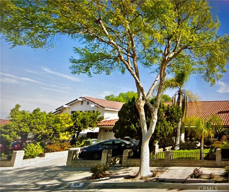 2270 Paso Real Ave, Rowland Heights, CA 91748 - obstructed view of property featuring a tiled roof and a fenced front yard