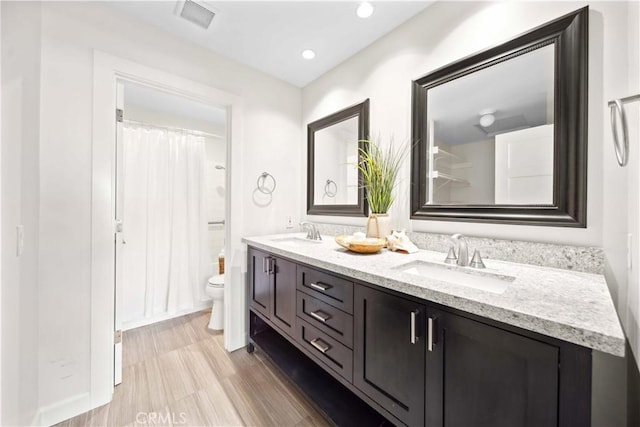 24833 Nueva Vista Dr Unit 2, Laguna Niguel, CA 92677 - full bathroom with toilet, double vanity, curtained shower, and recessed lighting