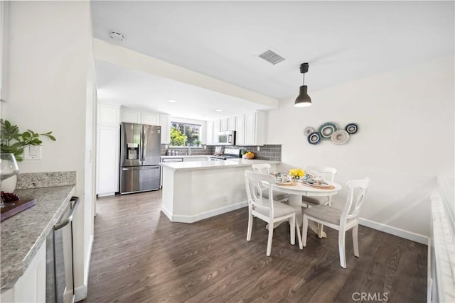 24833 Nueva Vista Dr Unit 2, Laguna Niguel, CA 92677 - dining space with wine cooler, dark wood-style flooring, and baseboards