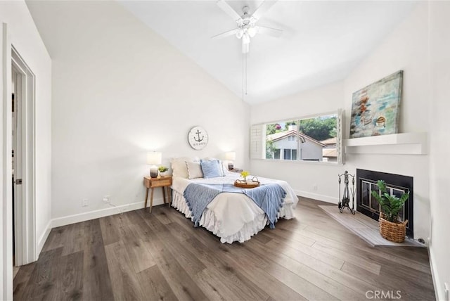 24833 Nueva Vista Dr Unit 2, Laguna Niguel, CA 92677 - bedroom featuring wood finished floors, baseboards, a fireplace with flush hearth, lofted ceiling, and a ceiling fan