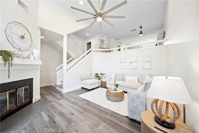 24833 Nueva Vista Dr Unit 2, Laguna Niguel, CA 92677 - living area with stairway, a ceiling fan, wood finished floors, recessed lighting, and a glass covered fireplace