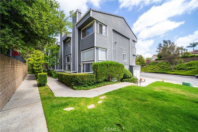 24833 Nueva Vista Dr Unit 2, Laguna Niguel, CA 92677 - view of property exterior with a yard and a chimney