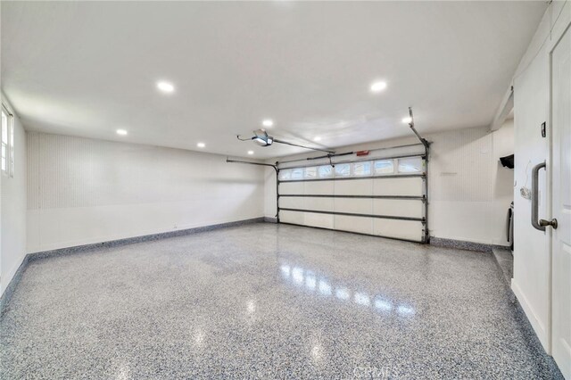 17121 Granada Ln, Huntington Beach, CA 92647 - garage featuring baseboards, recessed lighting, and a garage door opener