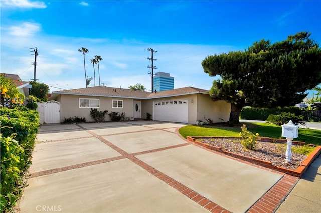 17121 Granada Ln, Huntington Beach, CA 92647 - ranch-style home with stucco siding, a gate, concrete driveway, and a garage