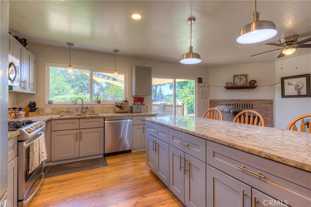 233 E Swift St, Orland, CA 95963 - kitchen featuring appliances with stainless steel finishes, a sink, gray cabinetry, healthy amount of natural light, and recessed lighting