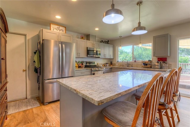 233 E Swift St, Orland, CA 95963 - kitchen with stainless steel appliances, gray cabinets, light stone counters, plenty of natural light, and recessed lighting
