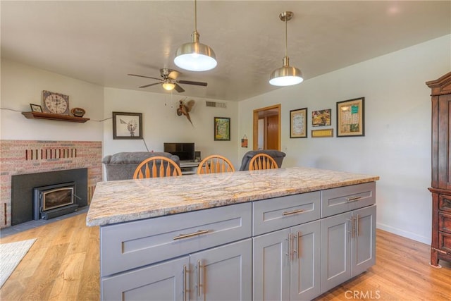 233 E Swift St, Orland, CA 95963 - kitchen with gray cabinetry, open floor plan, light wood-style floors, and a ceiling fan