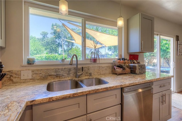 233 E Swift St, Orland, CA 95963 - kitchen with stainless steel dishwasher, a sink, plenty of natural light, and light stone counters