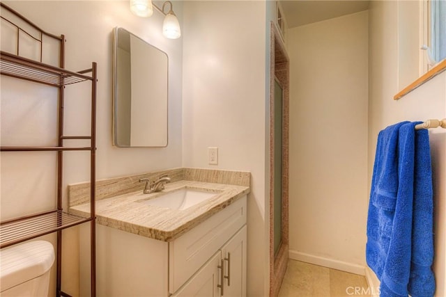 233 E Swift St, Orland, CA 95963 - bathroom featuring toilet, vanity, tile patterned flooring, and a shower with shower door