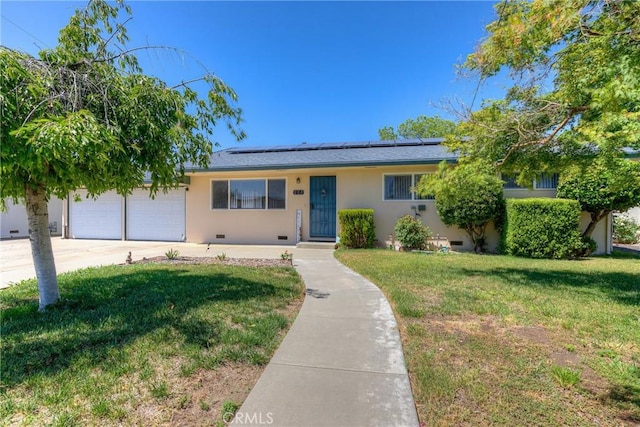 233 E Swift St, Orland, CA 95963 - ranch-style house with a front yard, solar panels, stucco siding, and a garage