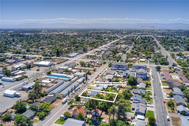 233 E Swift St, Orland, CA 95963 - aerial view of residential area with property parcel outlined and mountains