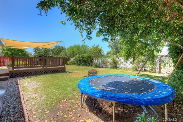 233 E Swift St, Orland, CA 95963 - view of yard featuring a trampoline, a deck, and a fire pit