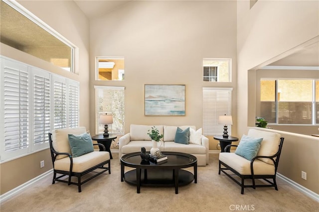 11 Berlamo, Rancho Santa Margarita, CA 92688 - living area with a towering ceiling, plenty of natural light, carpet floors, and baseboards