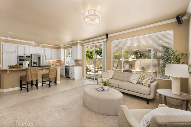 11 Berlamo, Rancho Santa Margarita, CA 92688 - living area featuring light tile patterned floors, crown molding, and baseboards