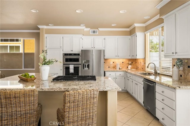 11 Berlamo, Rancho Santa Margarita, CA 92688 - kitchen featuring stainless steel appliances, a sink, ornamental molding, white cabinets, and recessed lighting
