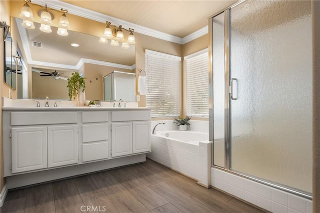 11 Berlamo, Rancho Santa Margarita, CA 92688 - bathroom with a stall shower, a bath, double vanity, ceiling fan, and ornamental molding