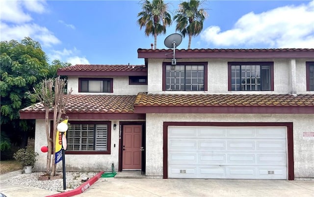 1125 Grand Ave E Unit A, Pomona, CA 91766 - view of front facade with a garage, driveway, stucco siding, and a tile roof