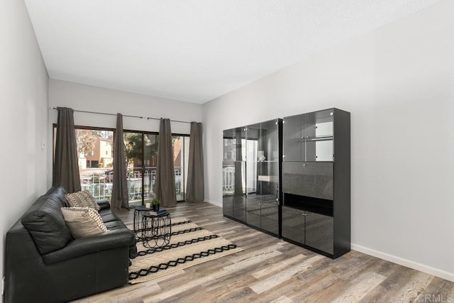 8328 Regents Rd Unit 1K, San Diego, CA 92122 - living room featuring wood finished floors and baseboards