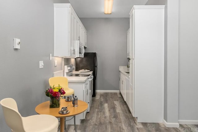 8328 Regents Rd Unit 1K, San Diego, CA 92122 - kitchen with white appliances, light countertops, wood finished floors, white cabinetry, and baseboards