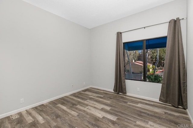 8328 Regents Rd Unit 1K, San Diego, CA 92122 - empty room with wood finished floors and baseboards
