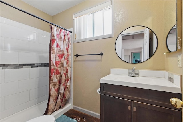 302 E 213th St, Carson, CA 90745 - full bathroom featuring vanity, tiled shower, toilet, wood finished floors, and baseboards