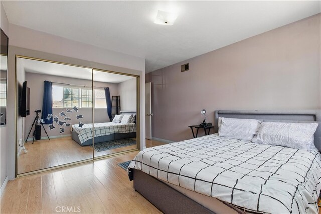 302 E 213th St, Carson, CA 90745 - bedroom with wood finished floors, a closet, and baseboards