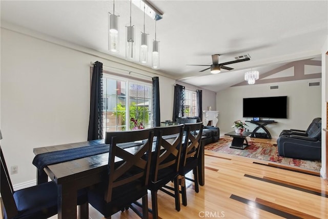302 E 213th St, Carson, CA 90745 - dining room featuring ceiling fan, light wood-type flooring, lofted ceiling, and a chandelier