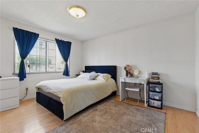 302 E 213th St, Carson, CA 90745 - bedroom featuring wood finished floors, a textured ceiling, and baseboards