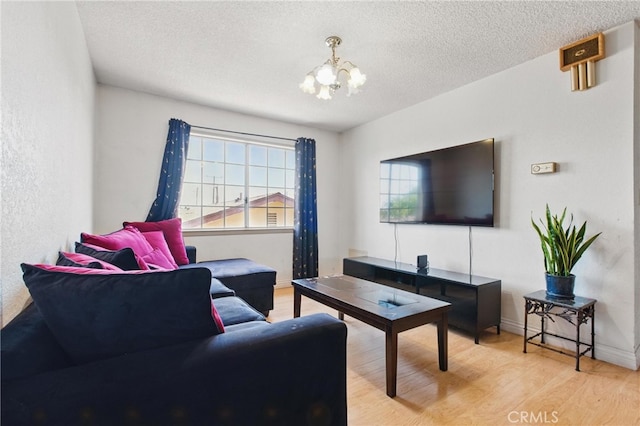 302 E 213th St, Carson, CA 90745 - living room featuring a chandelier, wood finished floors, a textured ceiling, and baseboards