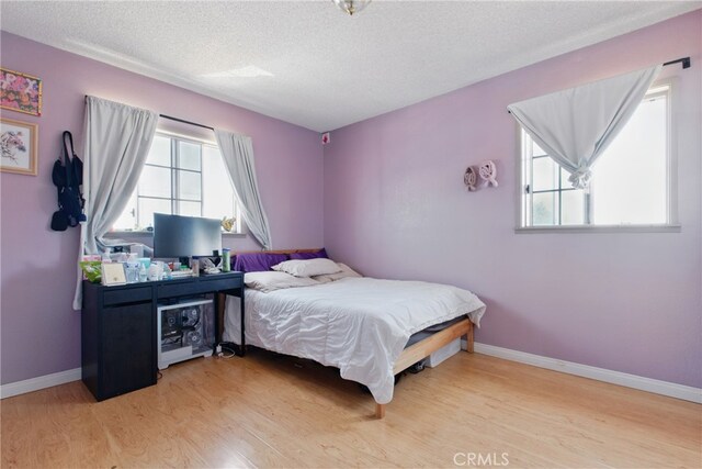 302 E 213th St, Carson, CA 90745 - bedroom featuring wood finished floors, a textured ceiling, and baseboards
