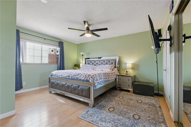 302 E 213th St, Carson, CA 90745 - bedroom featuring baseboards, wood finished floors, a textured ceiling, and a ceiling fan