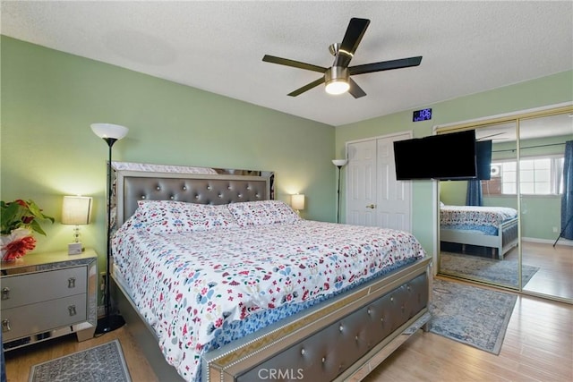 302 E 213th St, Carson, CA 90745 - bedroom featuring multiple closets, wood finished floors, a textured ceiling, and a ceiling fan