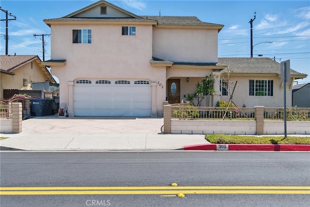 302 E 213th St, Carson, CA 90745 - view of front of home with driveway, an attached garage, and stucco siding
