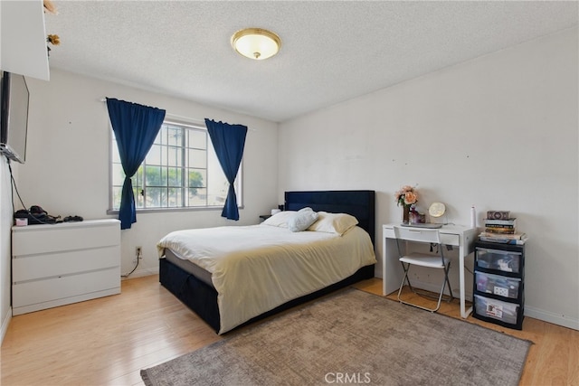302 E 213th St, Carson, CA 90745 - bedroom with wood finished floors, a textured ceiling, and baseboards