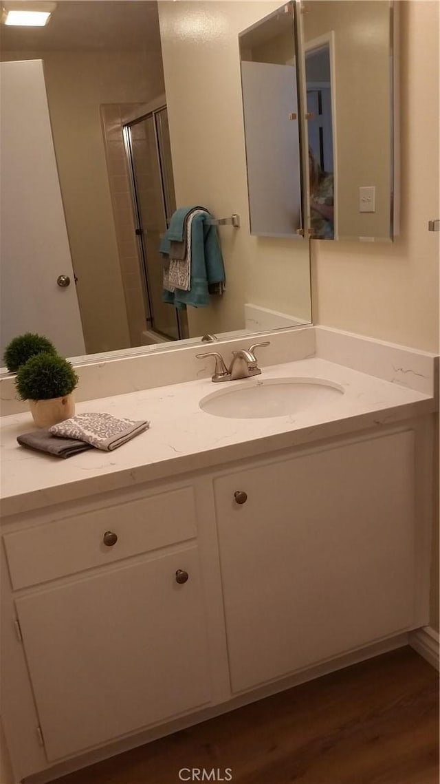 2652 College Ln, La Verne, CA 91750 - full bathroom featuring vanity, wood finished floors, and a shower with door