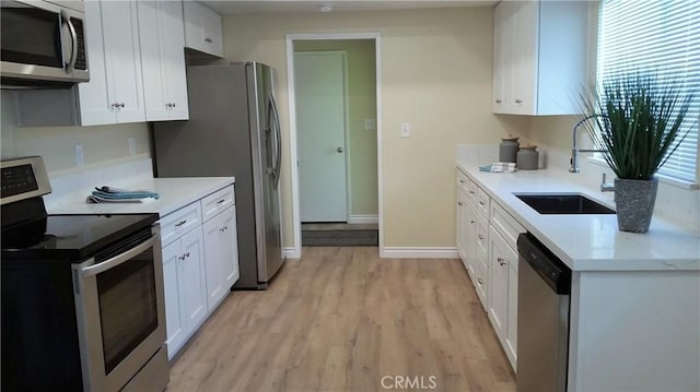 2652 College Ln, La Verne, CA 91750 - kitchen with appliances with stainless steel finishes, a sink, light wood-type flooring, and white cabinetry