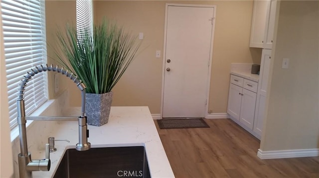2652 College Ln, La Verne, CA 91750 - kitchen featuring light wood-type flooring, white cabinetry, baseboards, and plenty of natural light