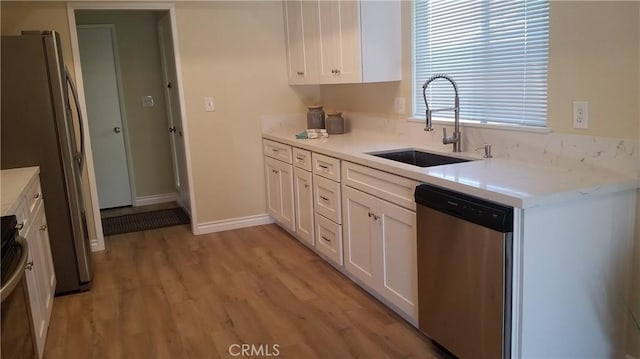 2652 College Ln, La Verne, CA 91750 - kitchen featuring stainless steel appliances, a sink, light wood-type flooring, white cabinetry, and light countertops