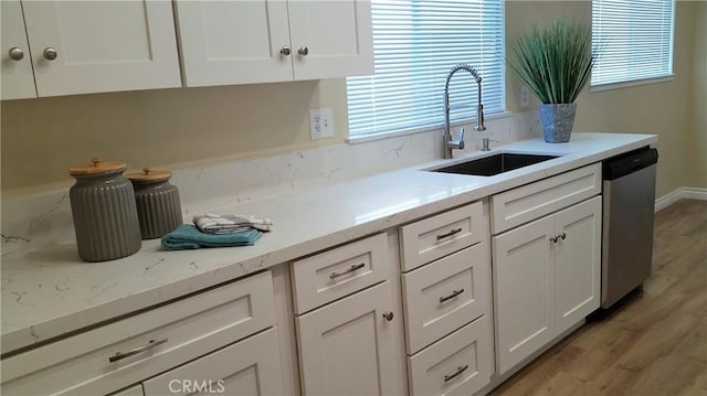 2652 College Ln, La Verne, CA 91750 - kitchen with dishwasher, a sink, white cabinets, and light wood-type flooring