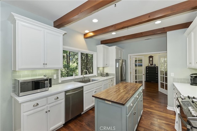 405 Terrace Rd, Lake Arrowhead, CA 92352 - kitchen with stainless steel appliances, a sink, wooden counters, backsplash, and white cabinetry
