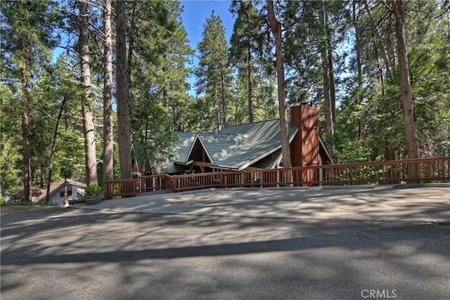 405 Terrace Rd, Lake Arrowhead, CA 92352 - view of side of property featuring a chimney, view of scattered trees, and driveway